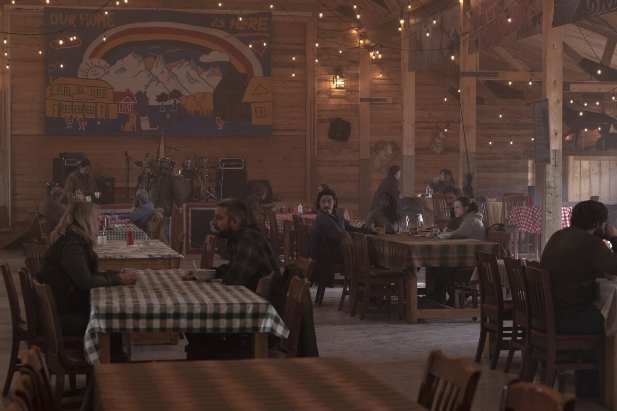 People seated at tables in a dimly lit room