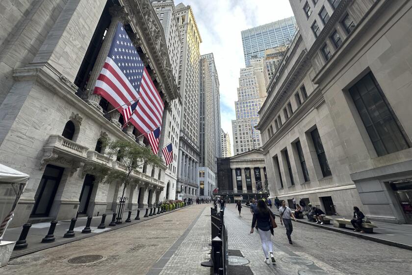 FILE - American flags hang from the front of the New York Stock Exchange on Sept. 11, 2024, in New York. (AP Photo/Peter Morgan, File)