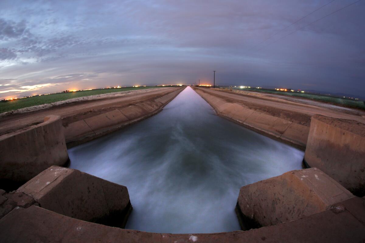 Irrigation water gushes through control gates and along the Rockwood Canal that channels Colorado River water to produce farms in Brawley. On Tuesday, the Metropolitan Water District of Southern California decided to restore water deliveries that had been cut because of drought.