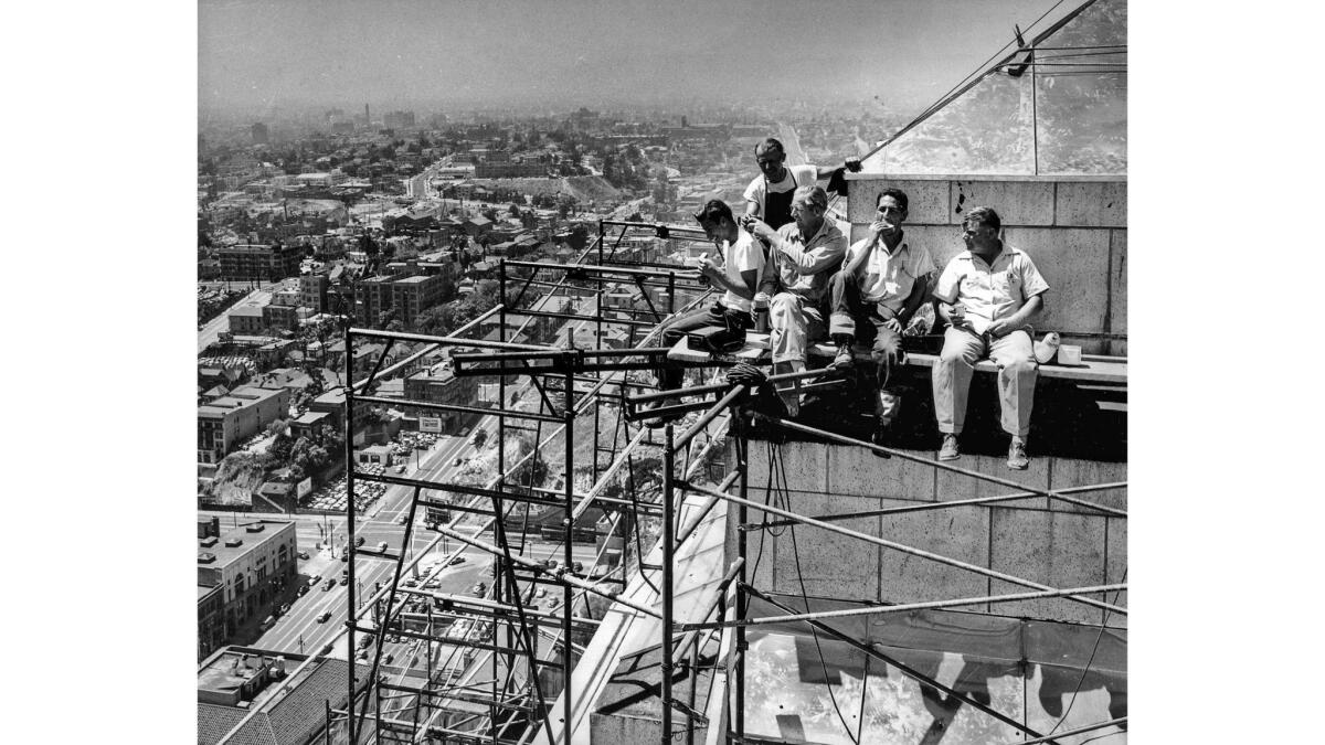 Aug. 16, 1950: Workers putting a stainless steel covering atop Los Angeles City Hall take a lunch break.