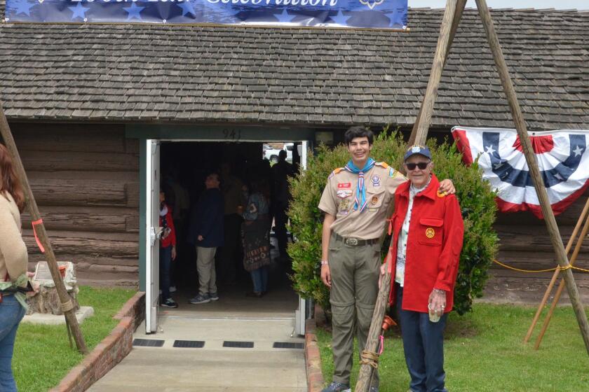 Dominic Ureno, Troop 1 Senior Asst. Patrol Leader with grandfather Johnny Etheridge, a former scout, at Paxson Cabin.