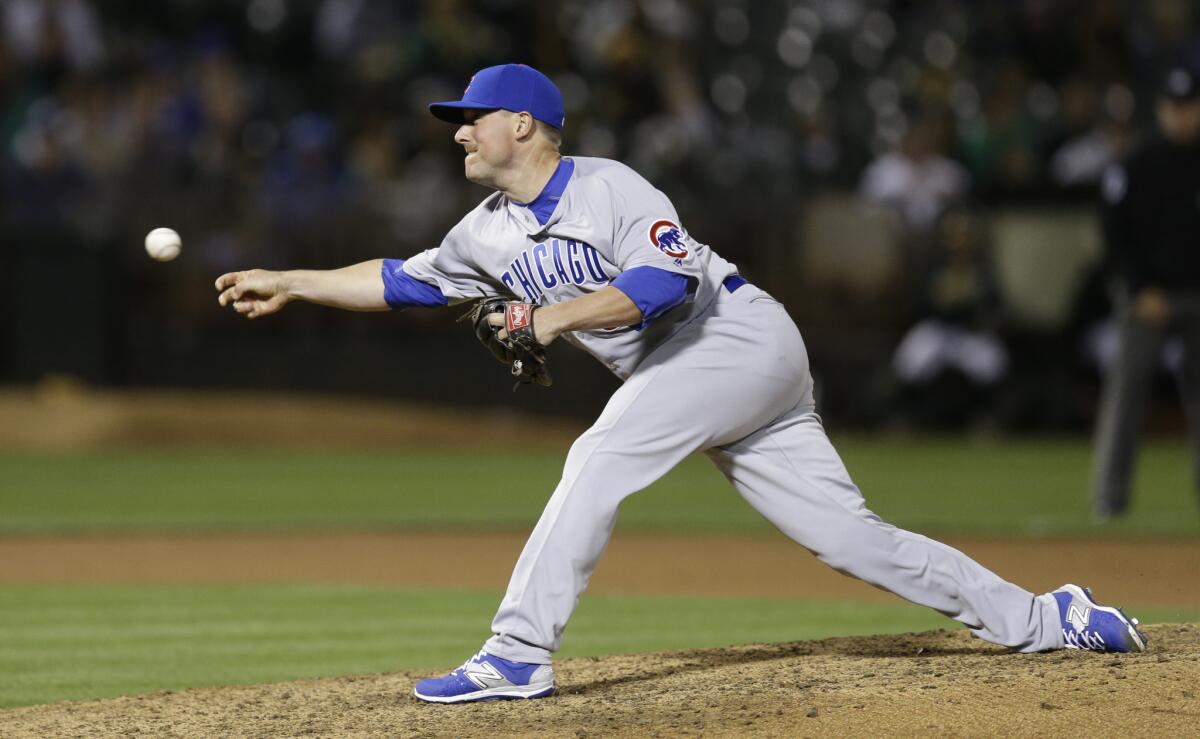 Cubs pitcher Joe Smith throws to an Oakland Athletics batter during the ninth inning on Aug. 5.