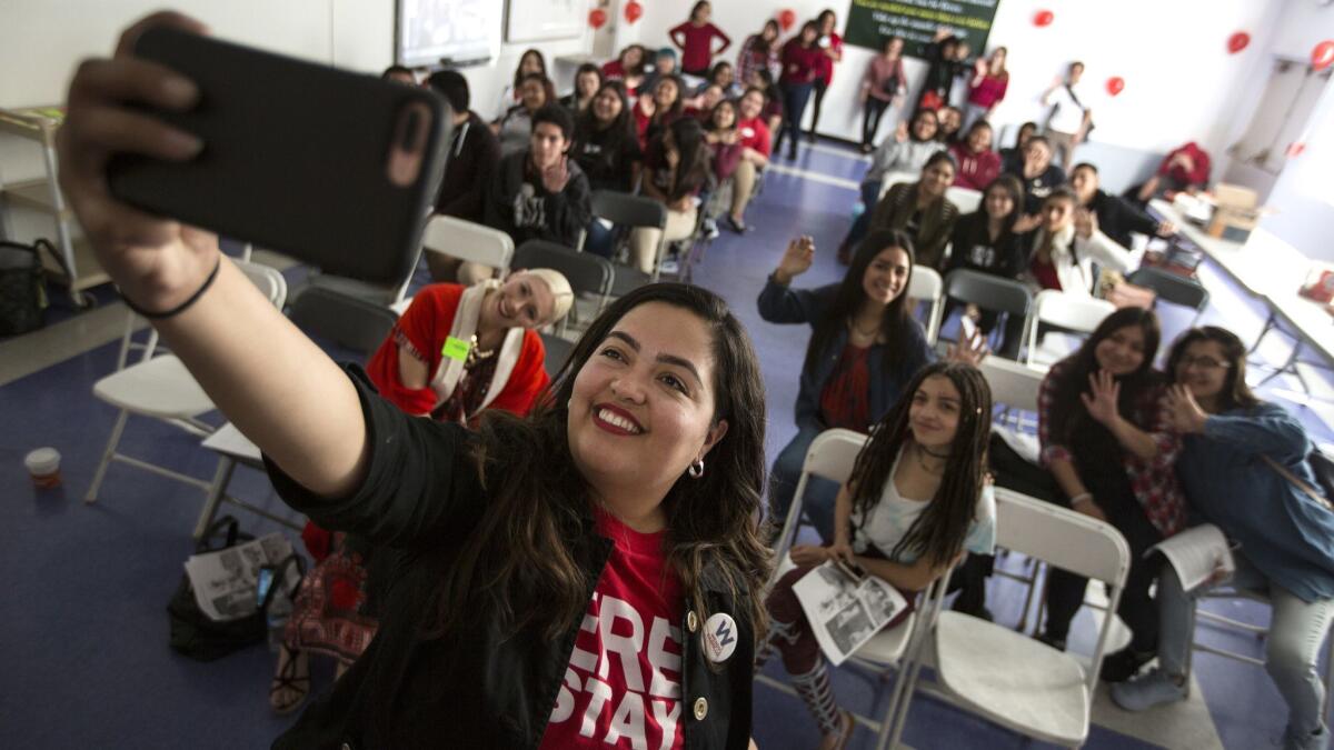 Assemblywoman Wendy Carrillo takes a group selfie with student group La Resistencia as they hold an event for International Women's Day at the Los Angeles Leadership Academy.