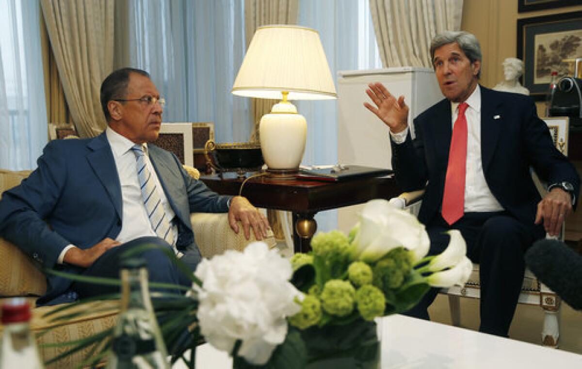 Russian Foreign Minister Sergei Lavrov, left, meets with U.S. Secretary of State John Kerry in Paris on Monday to discuss their plan to hold a peace conference on Syria next month. Although the Russians on Tuesday threatened to send missiles to Syrian President Bashar Assad, the Kremlin may not be sabotaging the peace talks so much as making contingency plans in the likely event that they fail, Middle East analysts said.