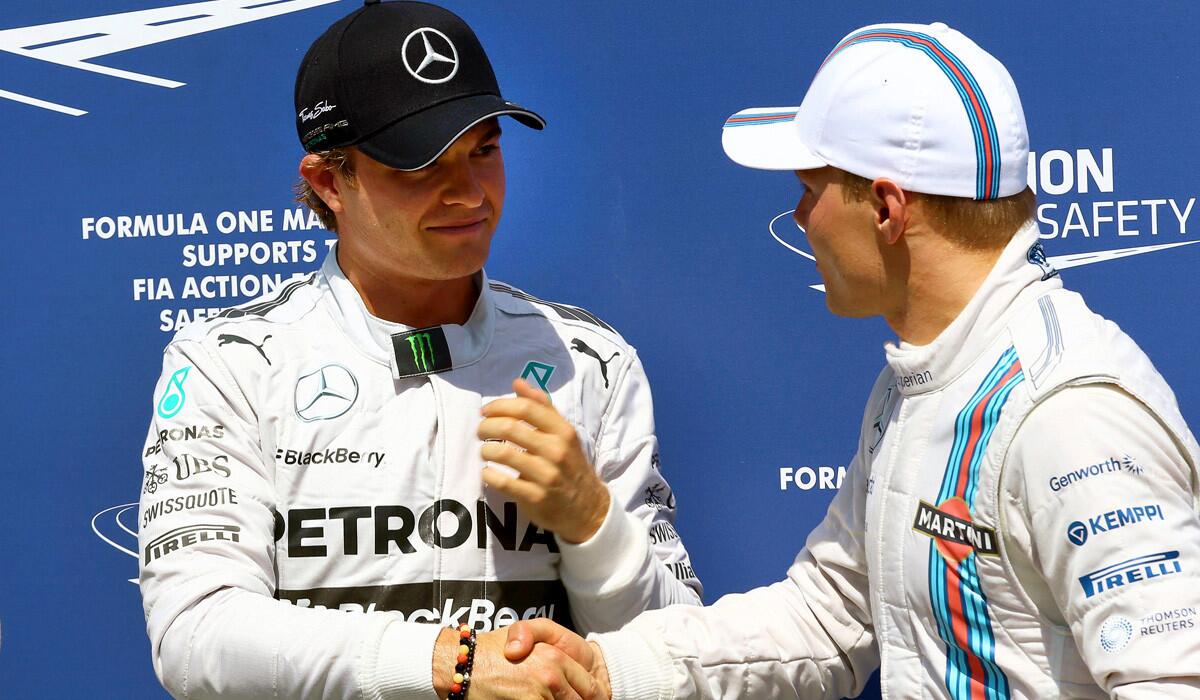 Formula One driver Nico Rosberg, left, is congratulated by Valtteri Bottas after they went one-two, respectively, in qualifying for the German Grand Prix on Saturday.