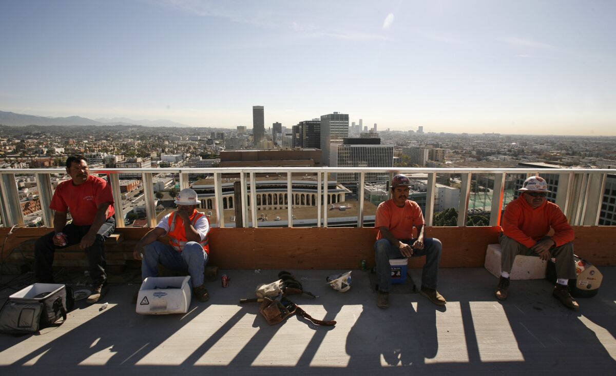 A study found that U.S. cities could warm an additional 3.6 degrees by 2100 unless they slow their expansion, paint roofs white or plant rooftop vegetation. Above, construction workers take a break on a Los Angeles rooftop.