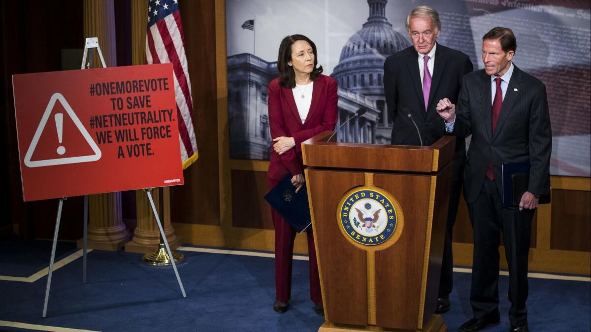 Sen. Richard Blumenthal (D-Conn.), right, speaks during a May 9 news conference on a Senate petition to force a vote to restore net neutrality regulations. With him are Sens. Maria Cantwell (D-Wash.) and Ed Markey (D-Mass.).