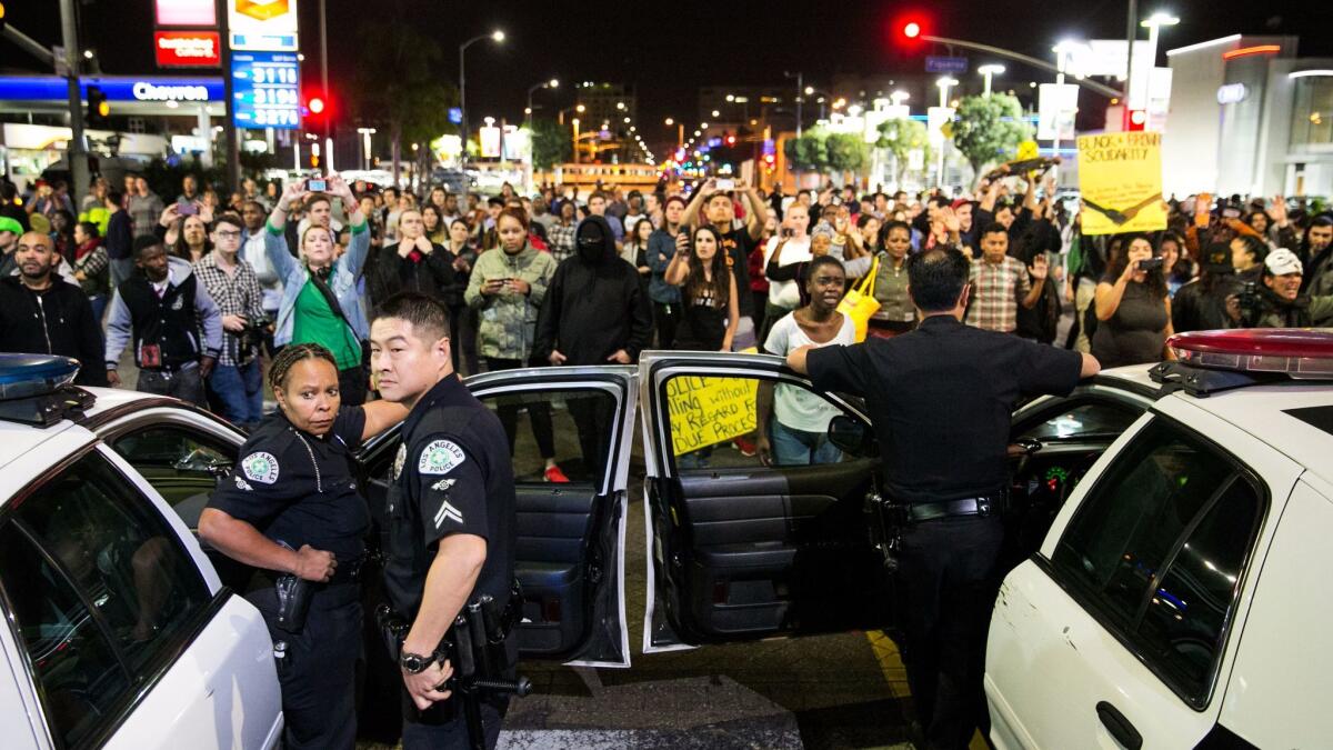 Protesters stare down Los Angeles police officers during a November 2014 demonstration against a Missouri grand jury's decision not to indict the officer who fatally shot Michael Brown. Protests erupted across the country after the announcement.