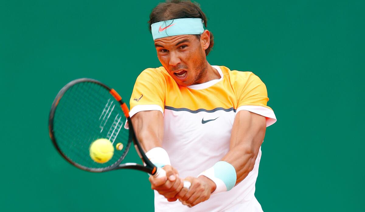 Rafael Nadal returns a shot against John Isner during their match Thursday at the Monte Carlo Masters in Monaco.