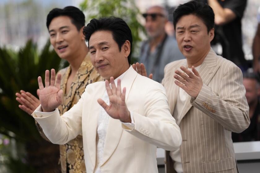 Ju Ji-hoon, from left, Lee Sun-kyun and Kim Hee-won pose for photographers at the photo call for the film 'Project Silence' at the 76th international film festival, Cannes, southern France, Monday, May 22, 2023. (Photo by Scott Garfitt/Invision/AP)