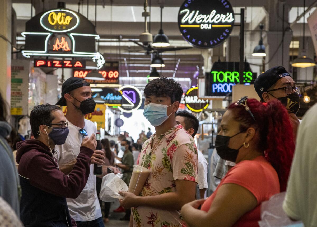 People in masks visit Grand Central Market