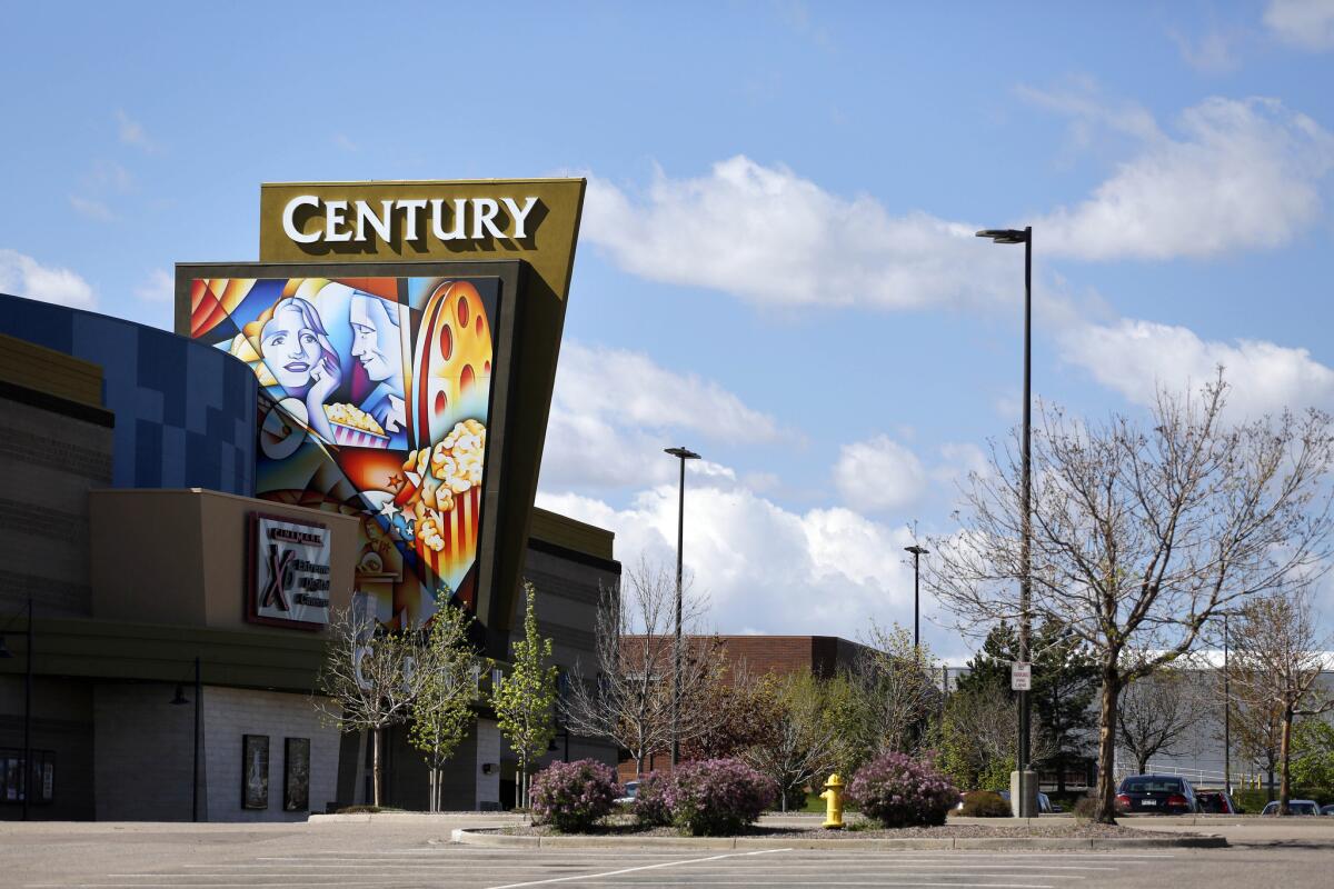 A colorful sign decorates the entrance of the Cinemark Century 16 movie theater in Aurora, Colo.