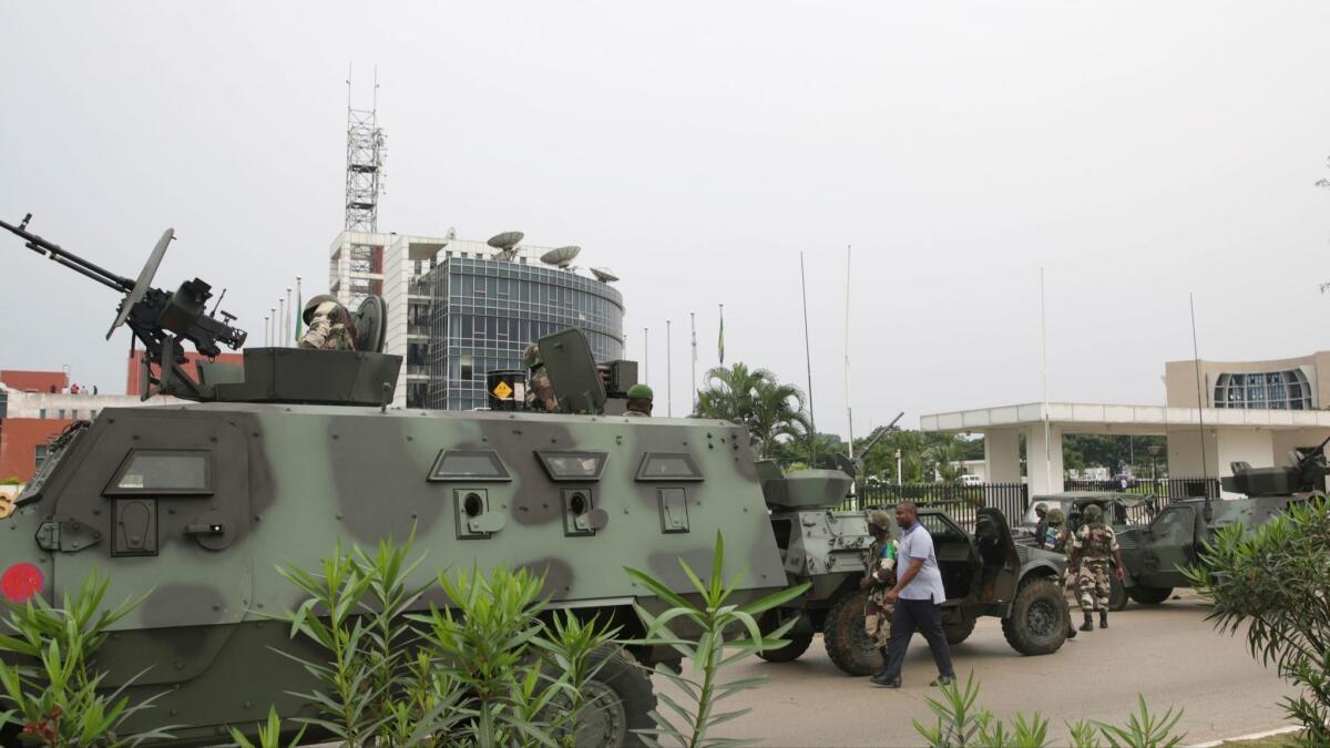 Gabonese soldiers patrol the site of national broadcaster Radiodiffusion Television Gabonaise in Libreville on Monday. Five army officers tried to take over state radio.