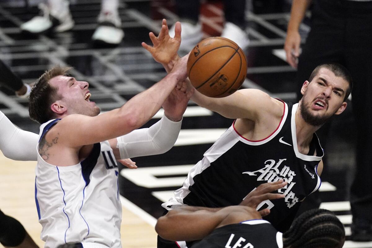Dallas Mavericks guard Luka Doncic, left, tries to shoots as Los Angeles Clippers center Ivica Zubac defends during the first half in Game 5 of an NBA basketball first-round playoff series Wednesday, June 2, 2021, in Los Angeles. (AP Photo/Mark J. Terrill)