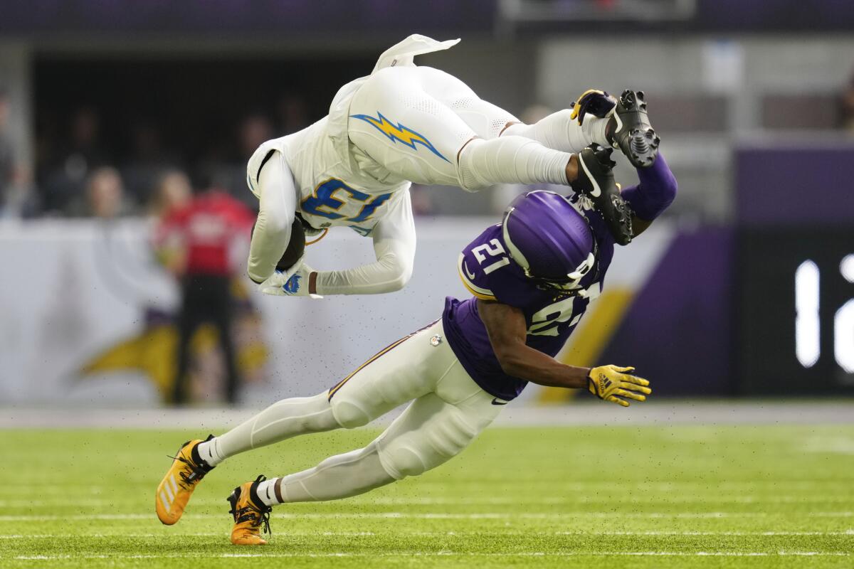 Chargers receiver Keenan Allen  is tackled by Vikings cornerback Akayleb Evans (21) after catching a pass.