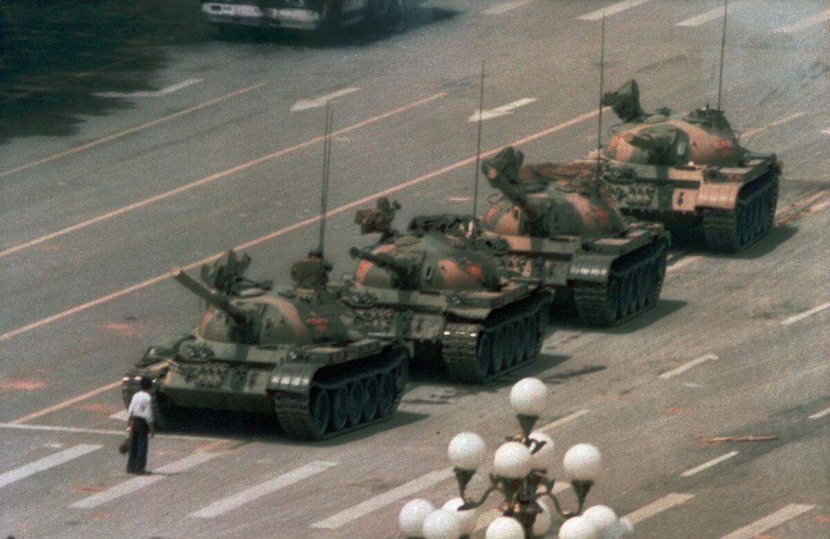 FILE - In this June 5, 1989, file photo, a Chinese man stands alone to block a line of tanks heading east on Beijing's Changan Blvd. in Tiananmen Square. An online snafu involving China’s most popular e-commerce livestreamer and a cake decorated to look like a tank, referencing the iconic Tank Man photo taken during the 1989 student-uprising, has raised questions among some Chinese over the violent crackdown on pro-democracy protests in Beijing's Tiananmen Square on June 4, 1989. (AP Photo/Jeff Widener, File)