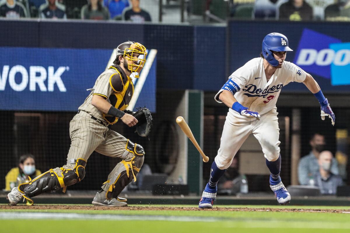 Cody Bellinger drops the bat to run to first after hitting a grounder for an error and the tying run.