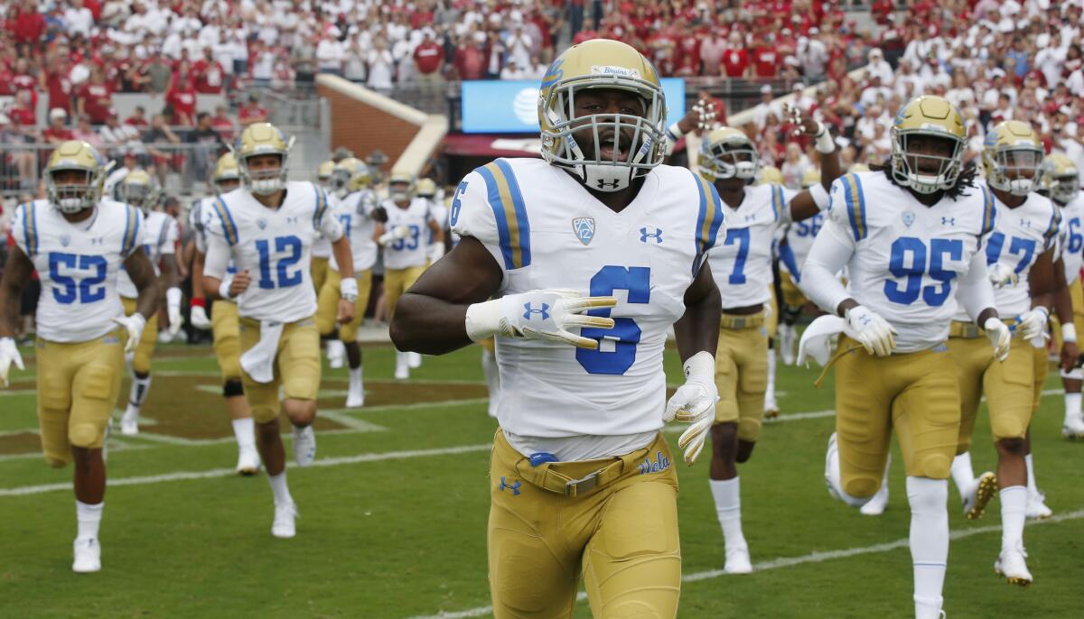 UCLA runs onto the field before a game against Oklahoma in Norman, Okla. on Sept. 8.