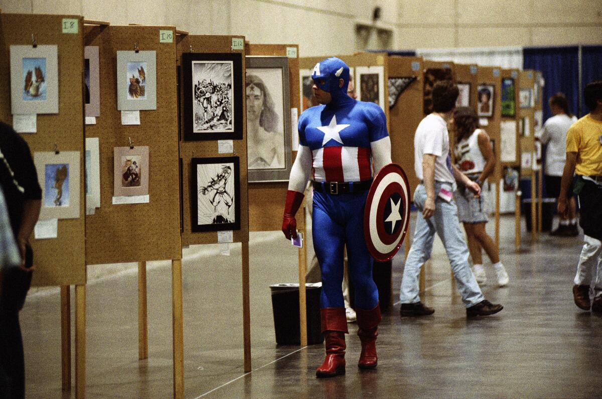 Dressed as Captain America, Jeff Holland of Meridian, Miss., walks through the art showcase at the San Diego Convention Center in 1994.