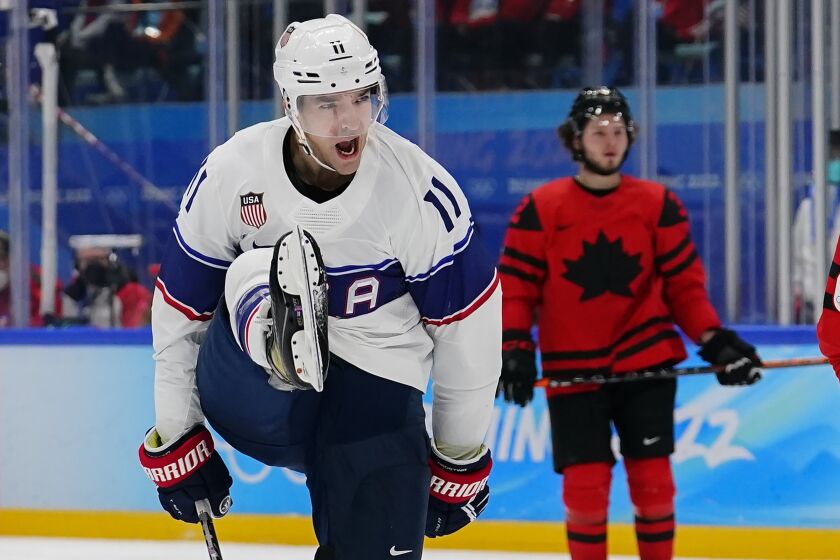 United States' Kenny Agostino (11) celebrates after scoring a goal against Canada during a preliminary round men's hockey game at the 2022 Winter Olympics, Saturday, Feb. 12, 2022, in Beijing. (AP Photo/Matt Slocum)