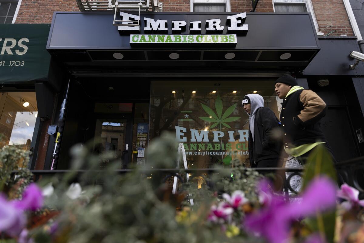 People walk past the Empire Cannabis Club  
