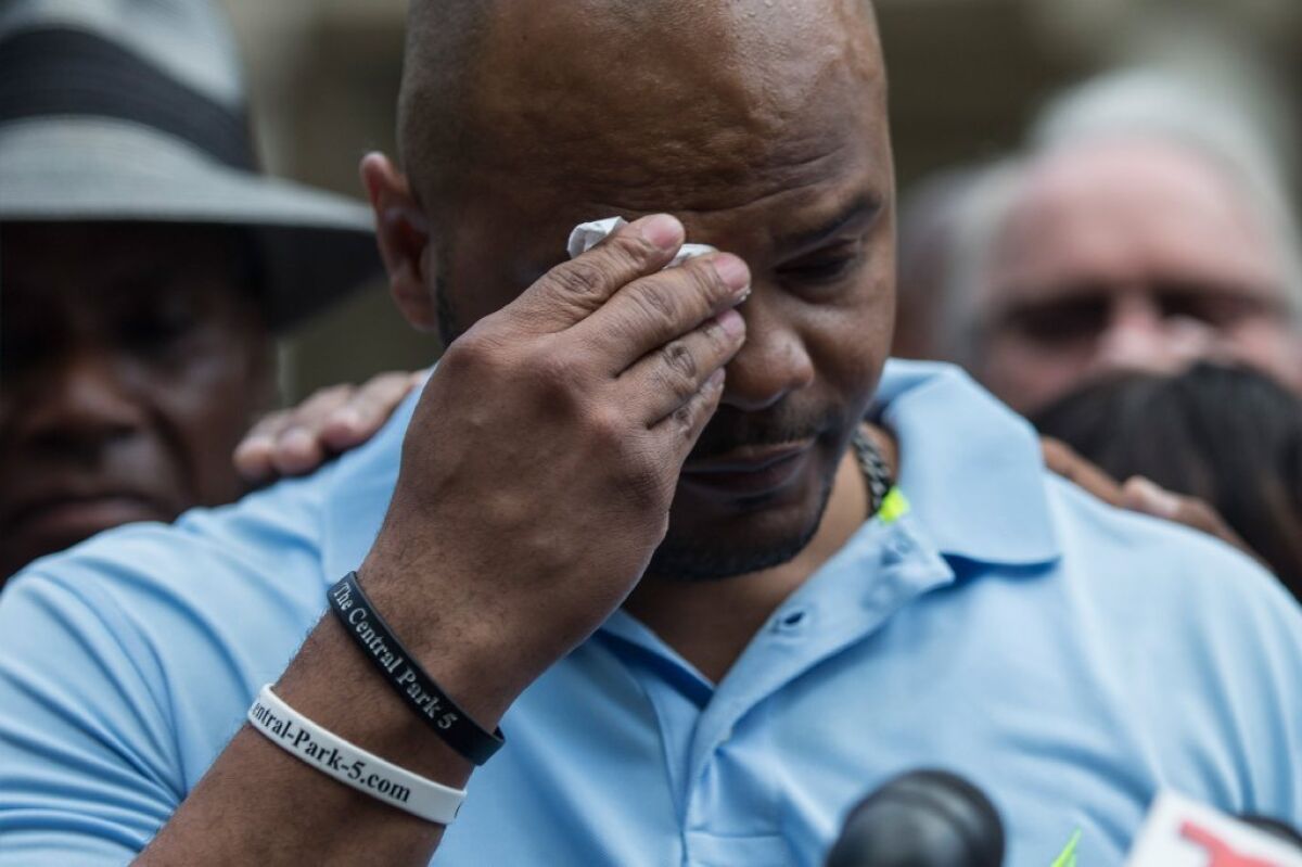 Kevin Richardson wipes away tears as he discusses a settlement he and four other men reached with New York City over their wrongful convictions in the 1989 Central Park Jogger case.