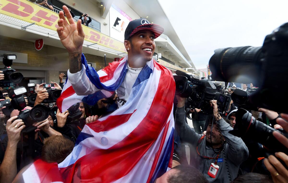 Formula One driver Lewis Hamilton celebrates his Grand Prix of U.S. victory at Circuit of The Americas on Sunday.