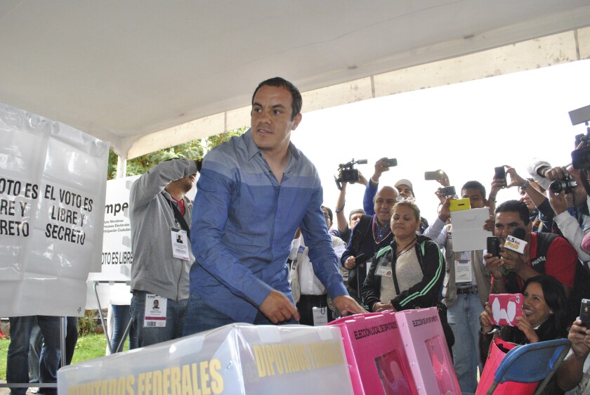FILE - Mexican soccer star Cuauhtemoc Blanco casts his vote during mid-term elections in Cuernavaca, Mexico, June 7, 2015. Blanco, the governor of Mexico’s Morelos state, denied on Tuesday, Jan. 4, 2022, any links to drug traffickers after a 3-year-old photo surfaced showing him posing with three men identified as local drug gang leaders. (AP Photo/Tony Rivera, File)