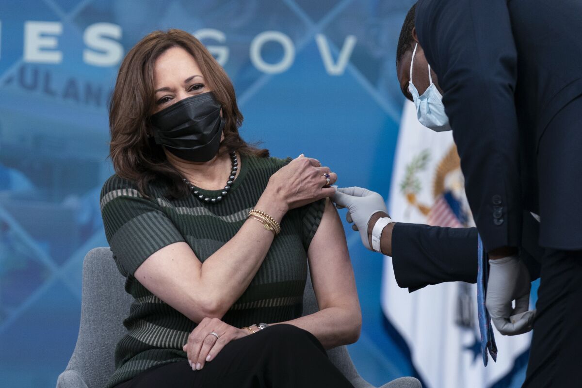 Administering White House medical staff wipes the arm of Vice President Kamala Harris as she is prepared to receive her Moderna COVID-19 vaccine booster shot at the Eisenhower Executive Office Building on the White House complex, in Washington, Saturday, Oct. 30, 2021. (AP Photo/Manuel Balce Ceneta)