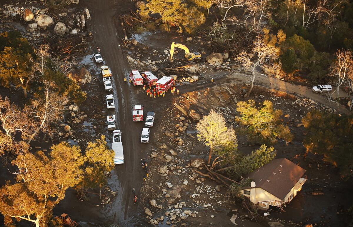 Crews work in the Romero Canyon area surrounded by mud and debris as seen from a California National Guard helicopter.