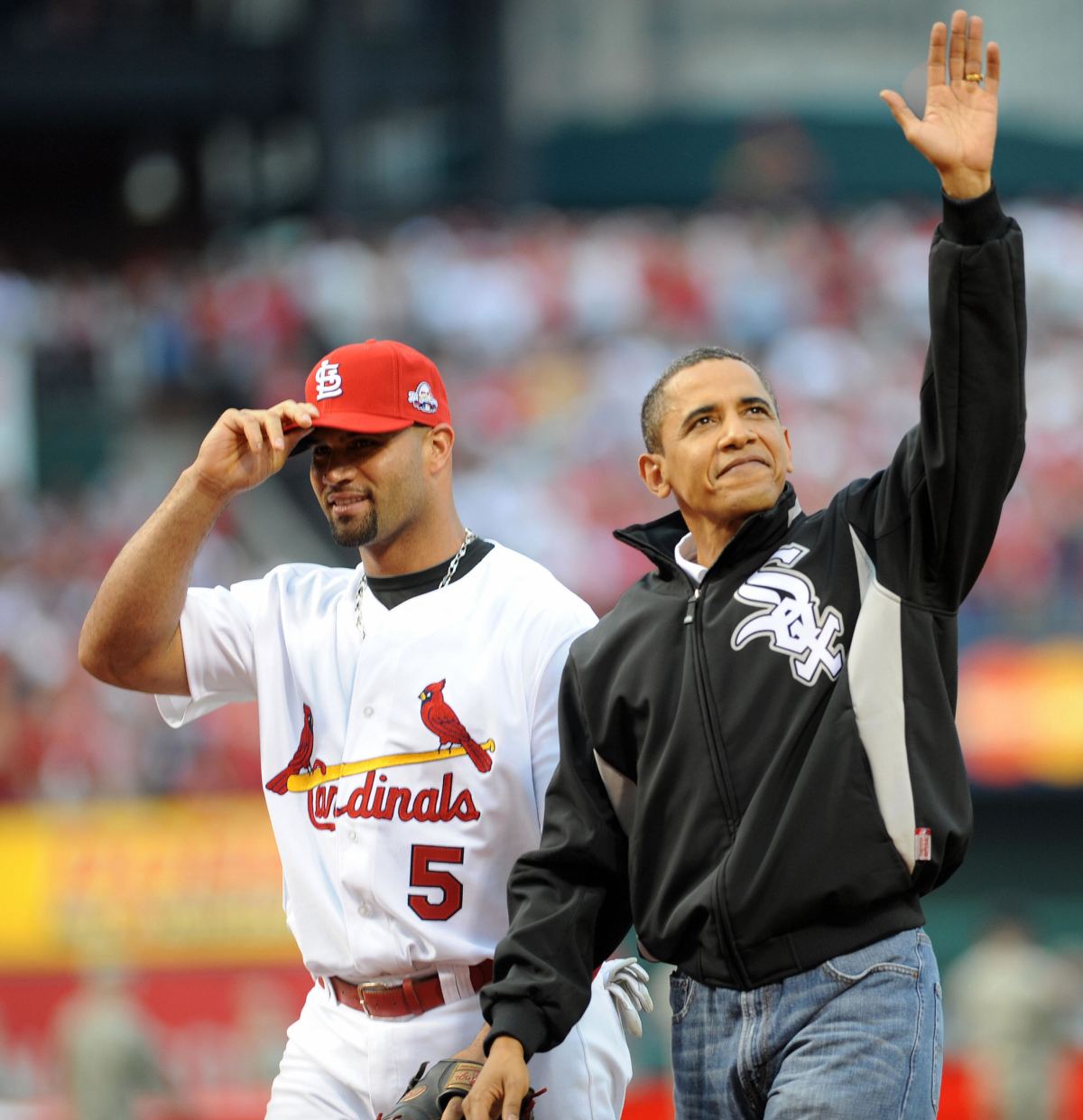 Barack Obama waves after throwing out the first pitch to Albert Pujols at the 2009 All-Star Game.
