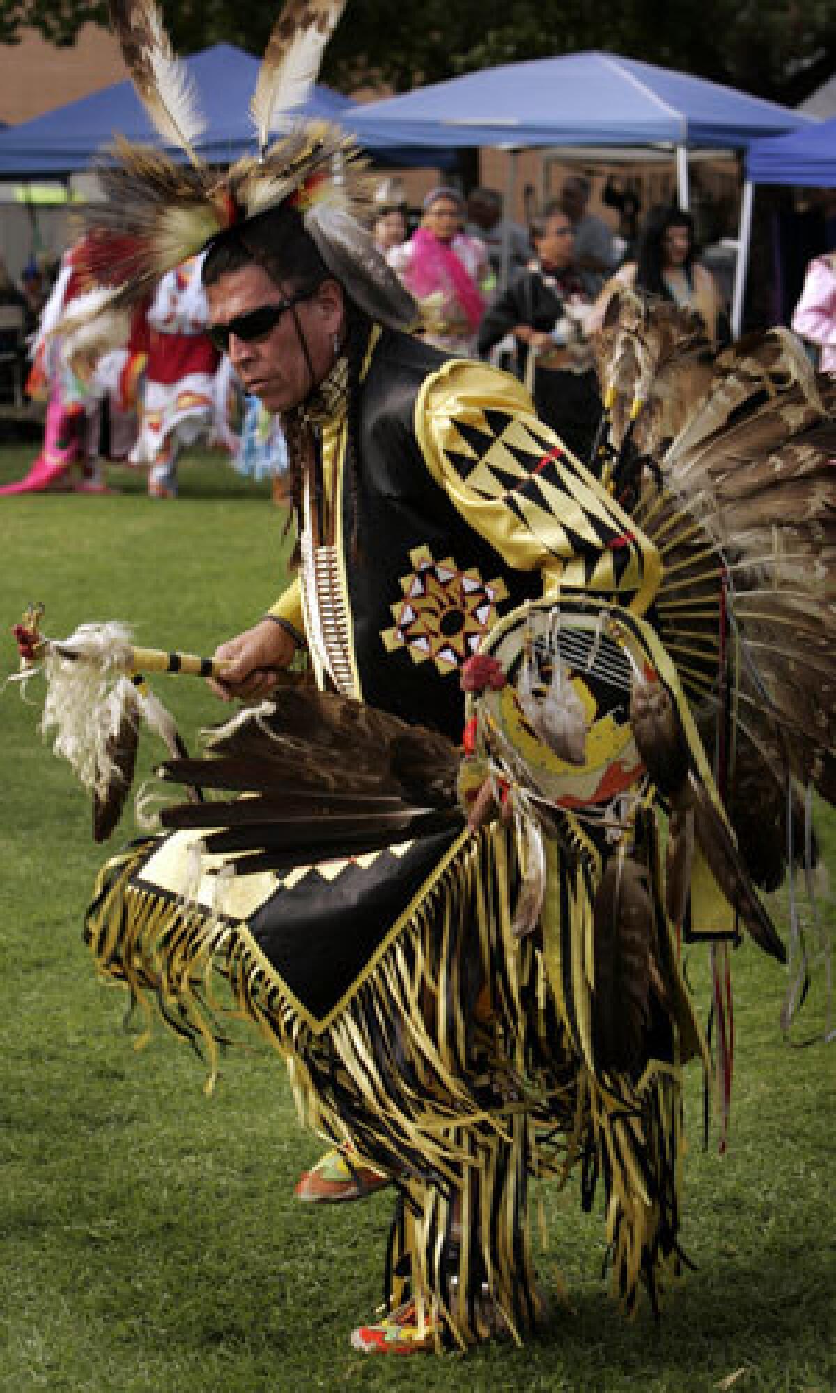 Sam Bearpaw performs a grand entry dance in a traditional Northern Plains warrior's outfit at a powwow held at Cal State Northridge in November 2007.
