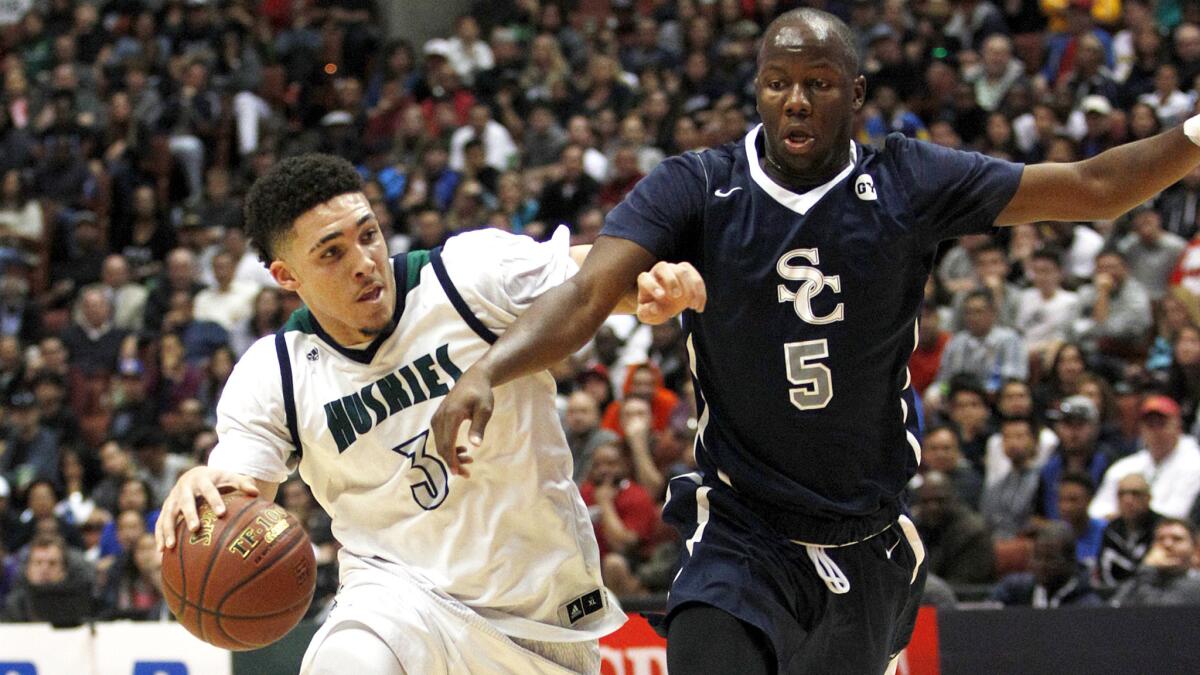 Chino Hills guard LiAngelo Ball (3) drives to the basket against Sierra Canyon's Adam Seiko (5) during the Southern Section Open Division championship game on Saturday night at Honda Center.