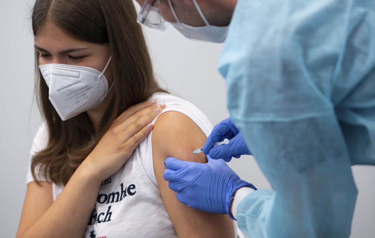 A student of a graduating class is vaccinated at the vaccination center at Messe Munich, Germany, Monday, July 12, 2021. (Sven Hoppe/dpa via AP)