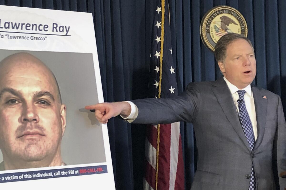 U.S. Atty. Geoffrey Berman announces the arrest of Lawrence Ray at a news conference Tuesday in New York.