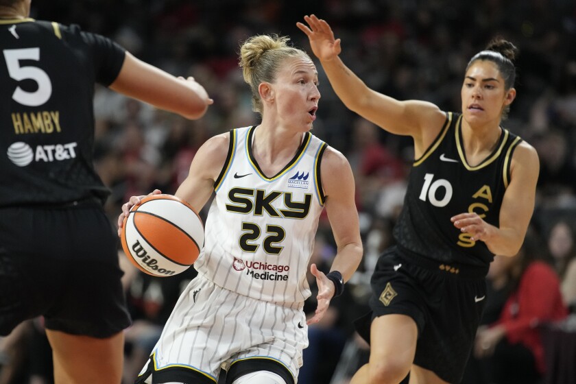Chicago Sky guard Courtney Vandersloot (22) drives around Las Vegas Aces guard Kelsey Plum (10) during the first half of a WNBA basketball game Tuesday, June 21, 2022, in Las Vegas. (AP Photo/John Locher)