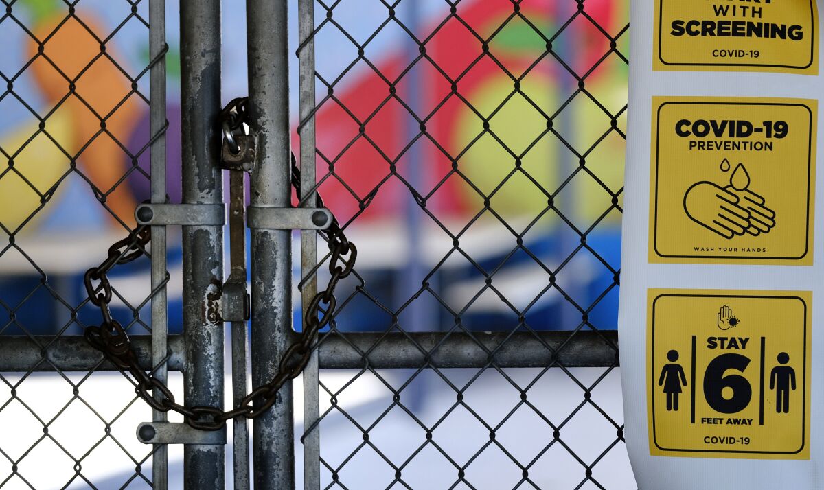 A gate is locked at a closed elementary school in July.