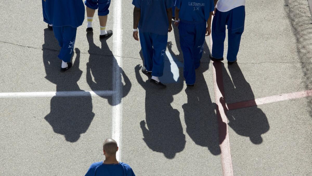 Inmates at North County Correctional Facility in Castaic, Calif. walk around the exercise yard on Oct. 11, 2017.