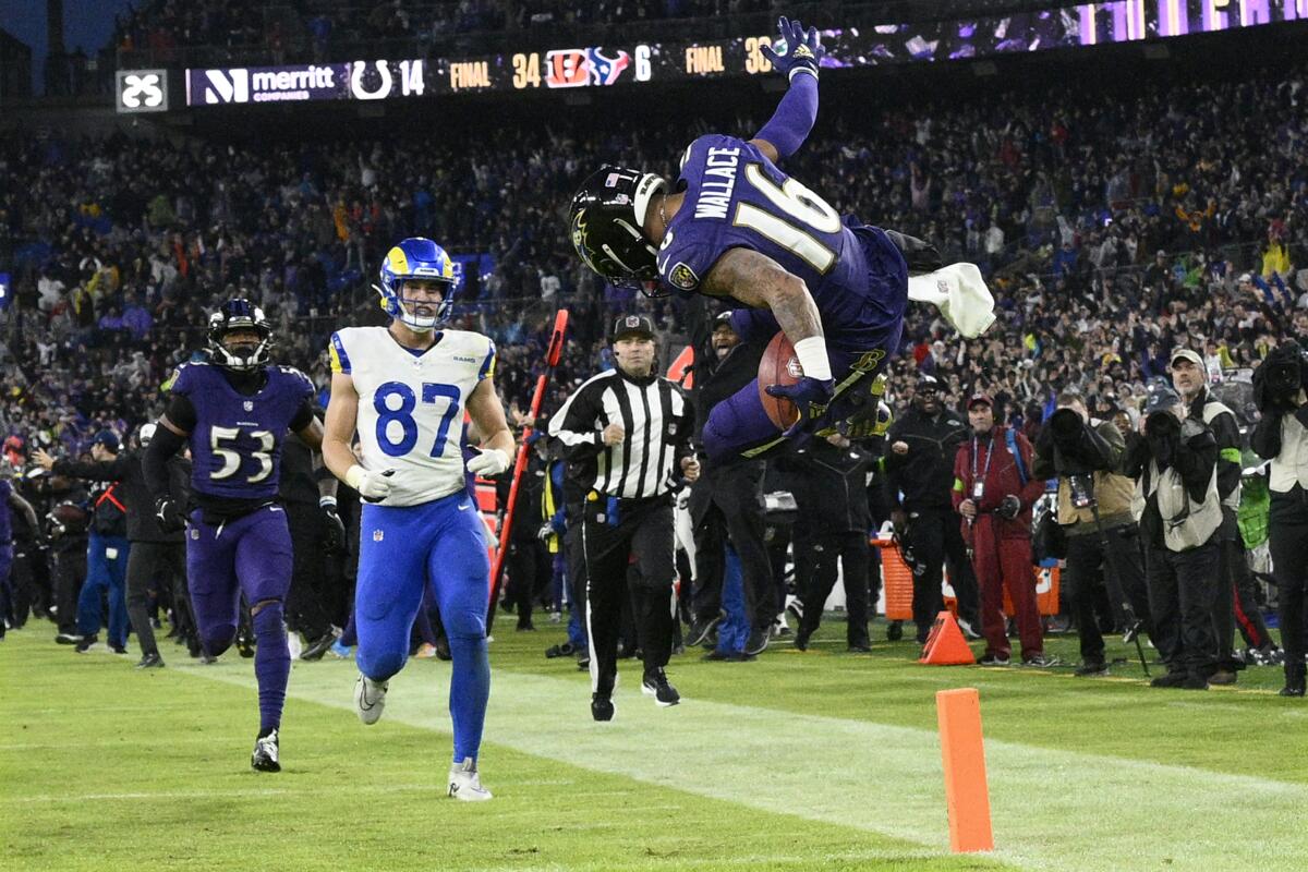 Tylan Wallace (16) flips into the end zone after his 76-yard punt return in overtime lifted the Ravens over the Rams.