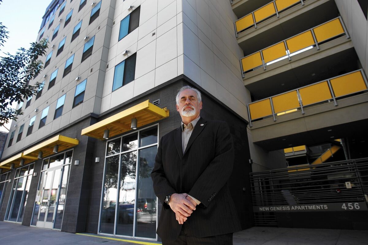 Robert Newman, property supervisor for Skid Row Housing Trust, stands in front of the New Genesis Apartments in downtown Los Angeles. The housing trust’s application for an alcohol permit for a restaurant on the premises has mushroomed into a symbolic fight for the soul of skid row.