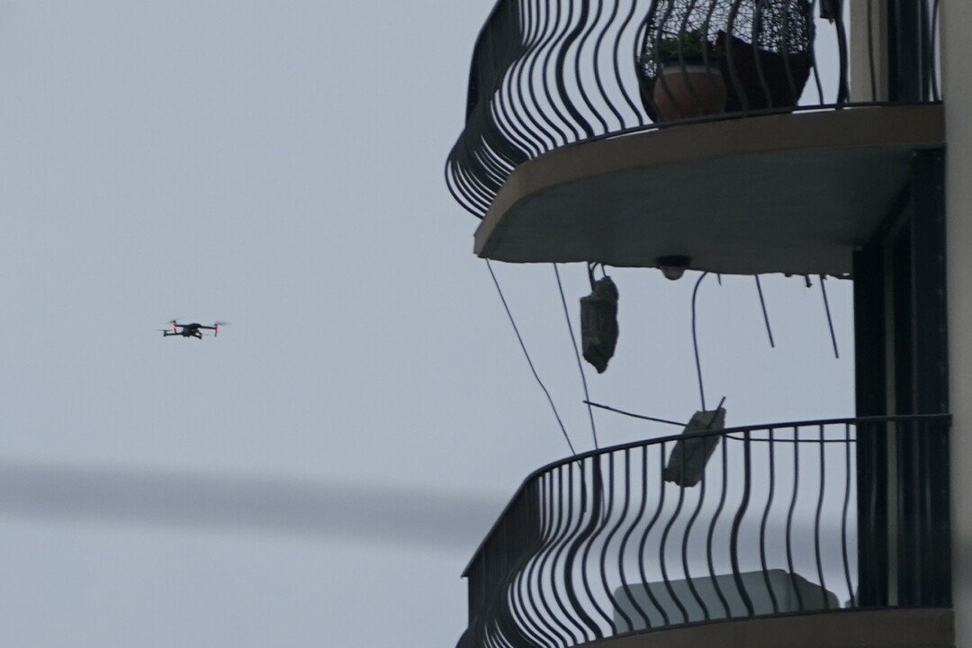 A drone inspects damage on a partially collapsed building in Surfside, Fla.