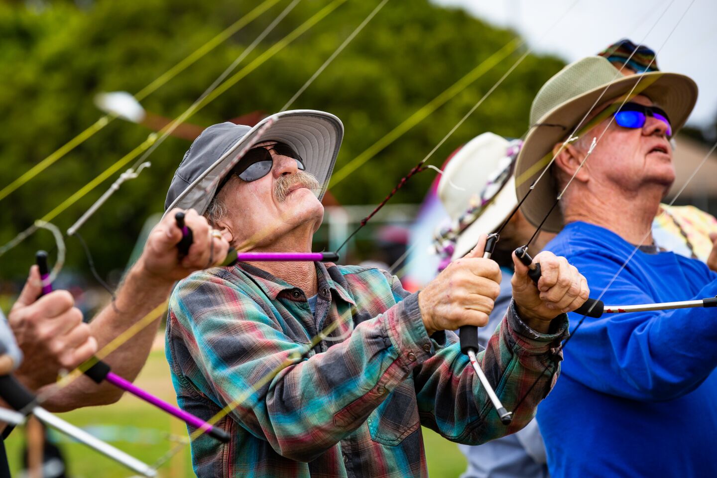 Mark Quirmbach (left) and Tom King maneuver their kites during Ocean Beach's Kite Festival at Robb Field.
