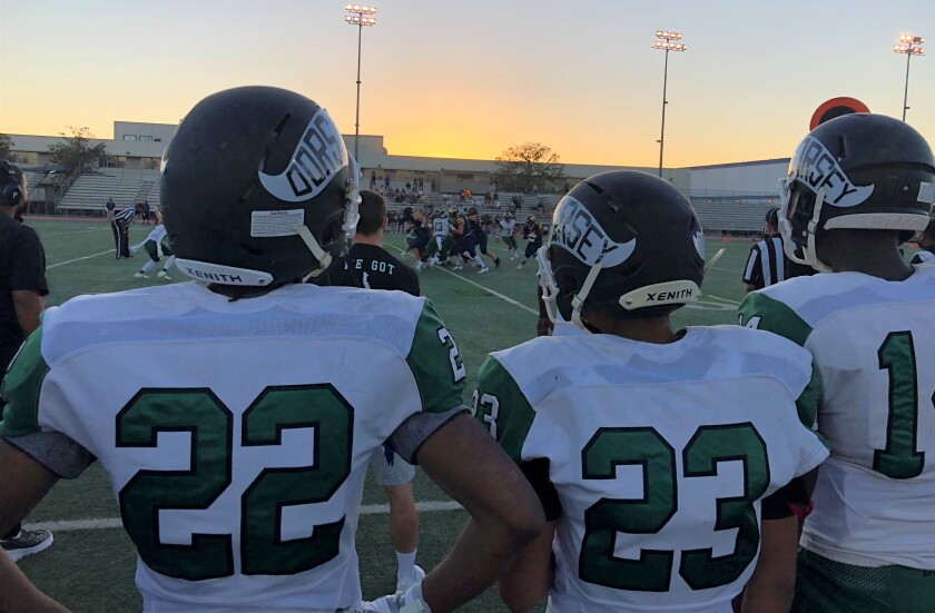 Dorsey reserves watch their teammates play against Santa Monica on Friday night at Jackie Robinson Stadium.