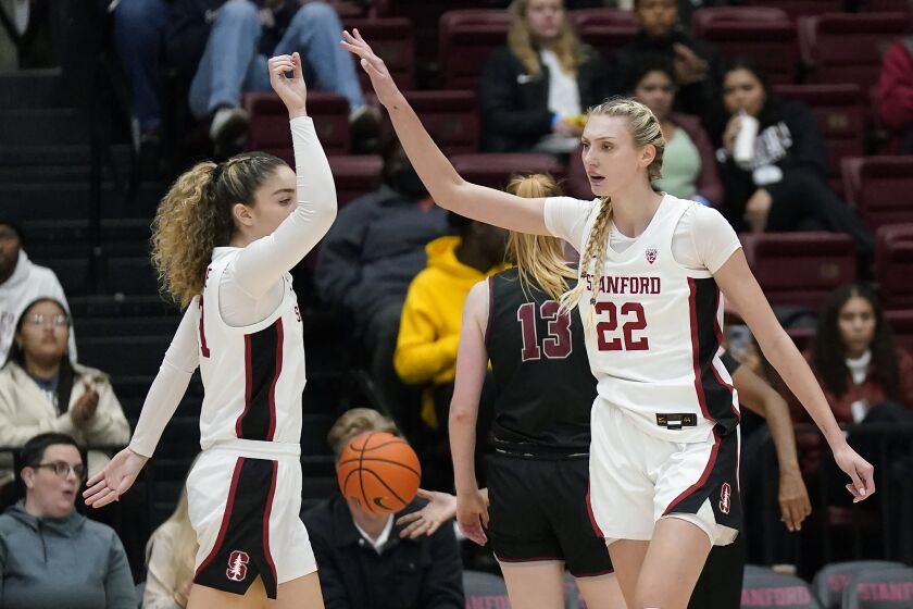 Stanford forward Cameron Brink (22) is congratulated by forward Brooke Demetre after scoring and being fouled during the first half of the team's NCAA college basketball game against Santa Clara in Stanford, Calif., Wednesday, Nov. 30, 2022. (AP Photo/Jeff Chiu)