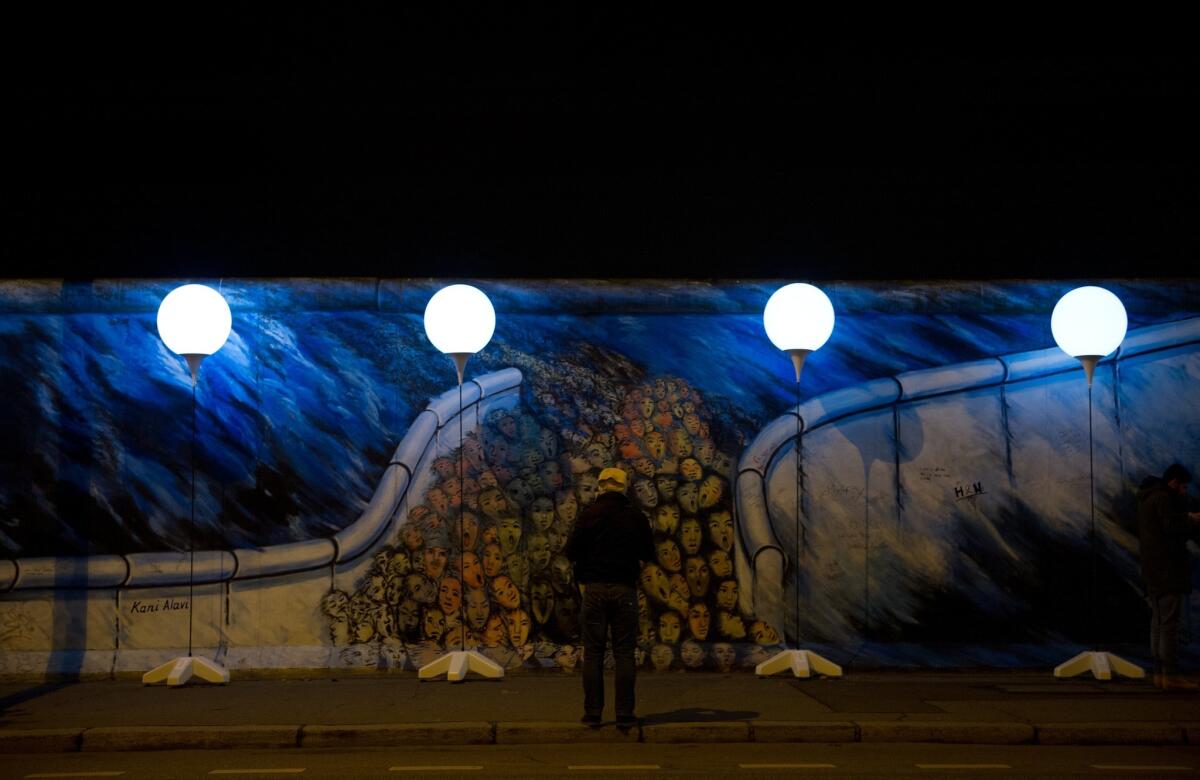 Lighted balloons trace the former path of the Berlin Wall, a public art installation to mark the 25th anniversary of the demise of the Cold War barrier. On Sunday's anniversary, the 8,000 balloons will be released.