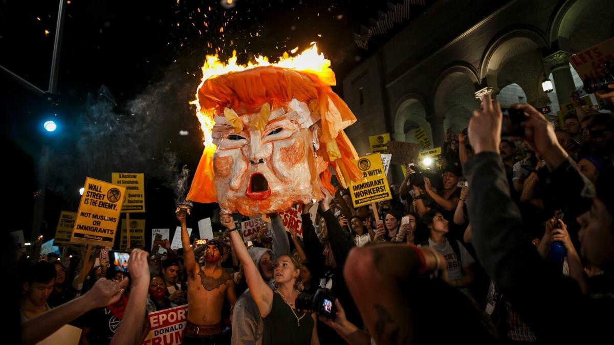 Protesters burn an effigy of Donald Trump outside Los Angeles City Hall.