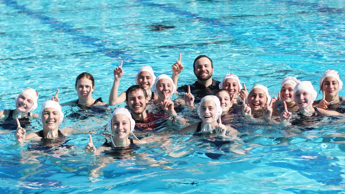 Coach Brandon Carman and the Torrey Pines Falcons celebrate their first-ever CIF girls water polo title.