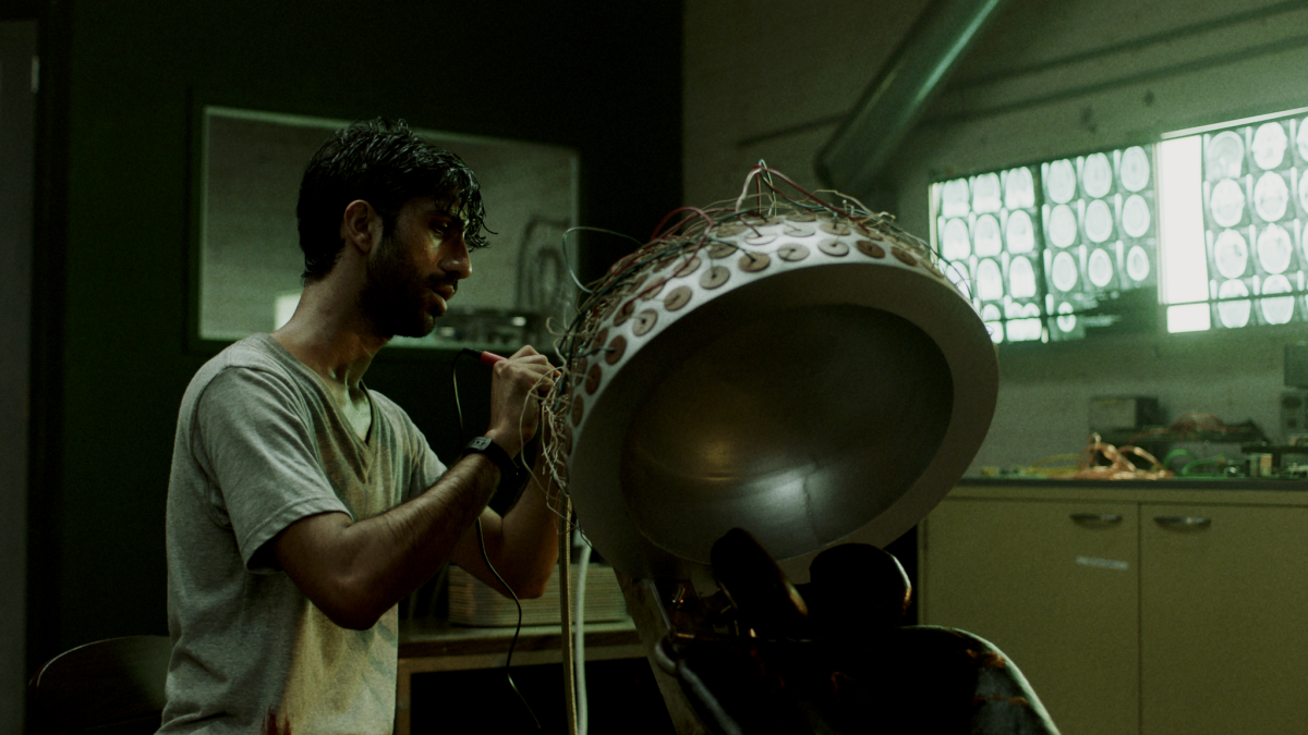 Sathya Sridharan with his brain-altering device in the thriller "Minor Premise."