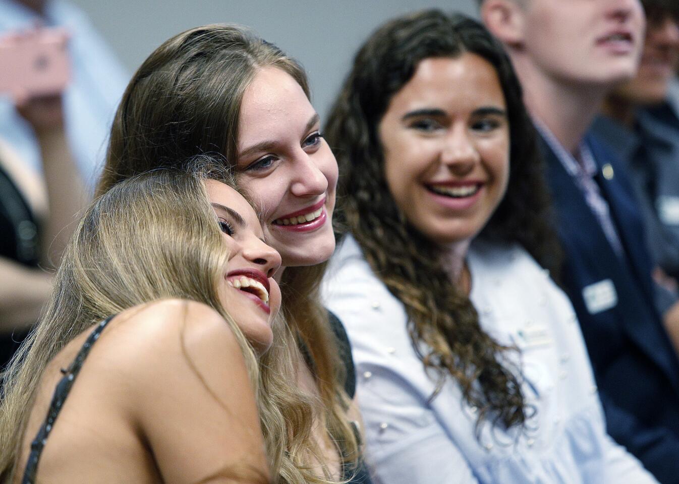 Esther Naranjo, of Madrid, Spain, laughs and puts her head on the shoulder of Veronica Muller, of La Canada High School, as they watch a video of photos of their time together at a City Council meeting on Tuesday, August 7, 2018. Participants in the La Canada Flintridge Sister Cities Association's exchange program of three students from Madrid, Spain, two students from La Canada High School, and one from St. Francis High School. The exchange students from Spain gave the City Council gifts, received certificates from Mayor Terry Walker, and watched a video of photos of their adventures.