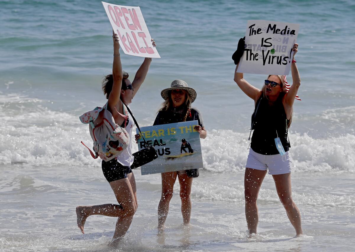 Protesters in Laguna Beach on Saturday call for California to reopen.